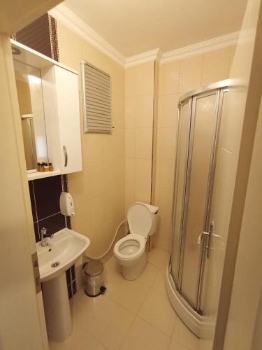 a bathroom with a toilet and a sink and a shower at Larok Hotel in Akcaabat