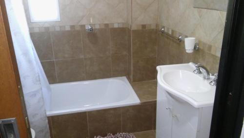 a bathroom with a sink and a toilet and a shower at Cabañas Rincon Verde in Merlo
