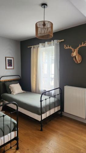 a bedroom with two bunk beds and a window at Le Clos des Souvenirs in Étretat