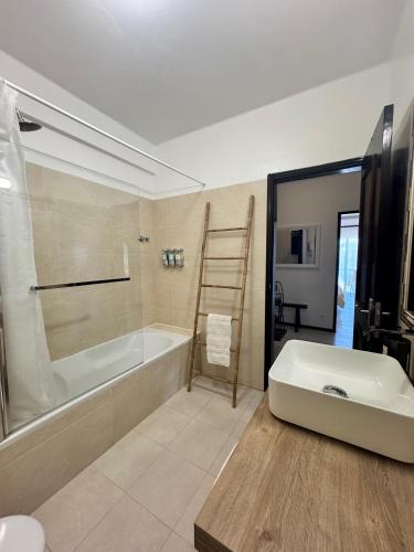 a bathroom with a bath tub and a sink at MHouse lease Cascais Spacious 3 BR Family next center in Alcabideche