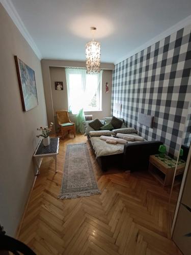 a living room with a couch and a table at Apartament 16 in Sandomierz