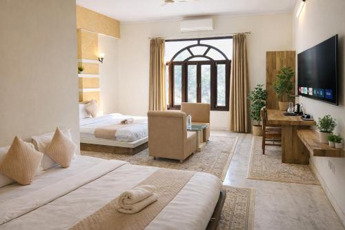 a hotel room with a bed and a television at Hotel Nomadic in Udaipur
