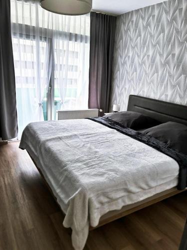 a bedroom with a large bed in front of a window at Burgberg-Oase in Bad Harzburg