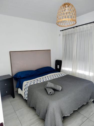 a bedroom with a bed with a hat on it at Salvia in Trenque Lauquen