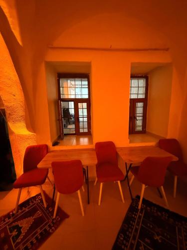 a room with a table and chairs and windows at Ro House in Mardin