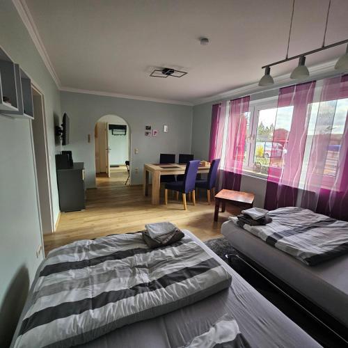 a bedroom with a bed and a dining room at Gartenblick Trebbin in Trebbin