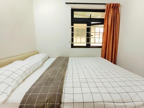 a bed in a room with a window at 365 House by D'Laksamana in Malacca