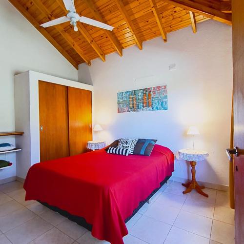 a bedroom with a red bed and a ceiling at San Luis Aparts in Carpintería