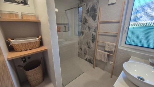a bathroom with a shower and a sink at Ta World apartments in Spodnji Log