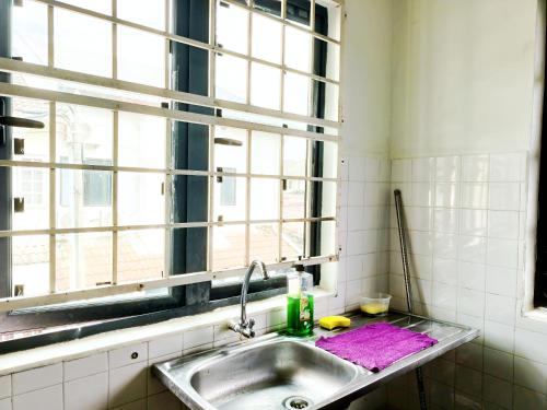 a kitchen with a sink and a window at 365 by D'Laksamana in Malacca