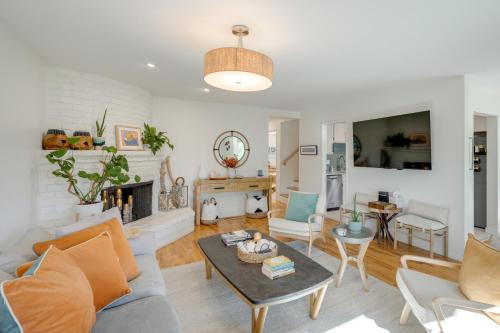 a living room with a couch and a table at Seaside Home with Hot Tub and Patio Close to Beaches! in Seaside