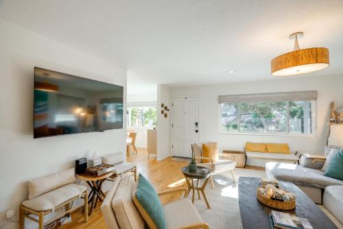 a living room with a couch and a table at Seaside Home with Hot Tub and Patio Close to Beaches! in Seaside