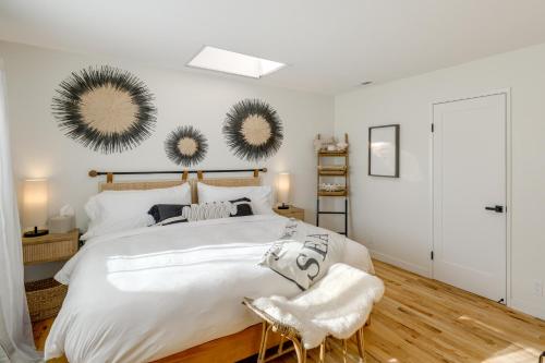 a bedroom with a large white bed with two mirrors on the wall at Seaside Home with Hot Tub and Patio Close to Beaches! in Seaside