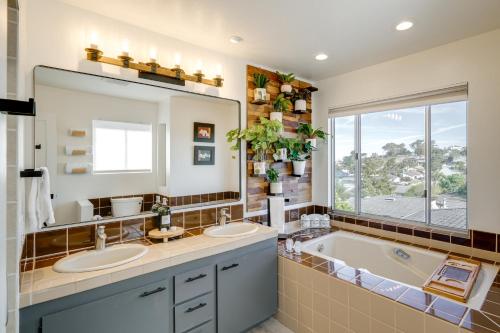 a bathroom with two sinks and a large mirror at Seaside Home with Hot Tub and Patio Close to Beaches! in Seaside