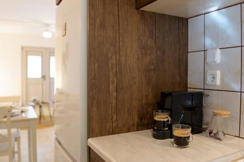 a kitchen with a counter with two cups on it at Fereniki's place in Gaios