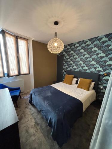 a bedroom with a large bed and a large wall at Au Saint Martin in Cholet