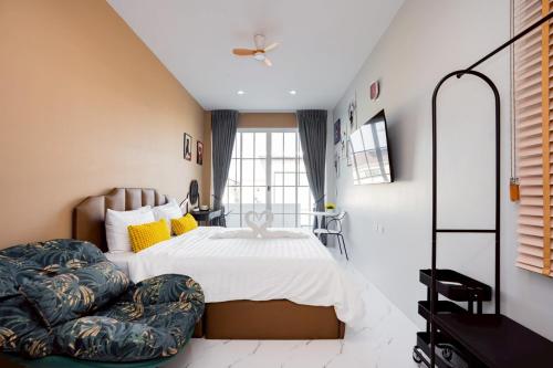 a bedroom with a large bed and a chair at Only U Home-Stay Villa Huahin in Hua Hin