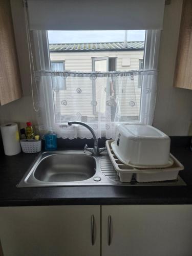 a kitchen counter with a sink and a window at F86 Steeple Bay in Steeple
