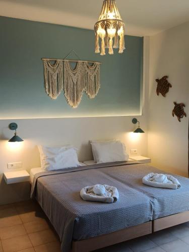 a bedroom with a bed with two towels on it at Liros in Kamiros
