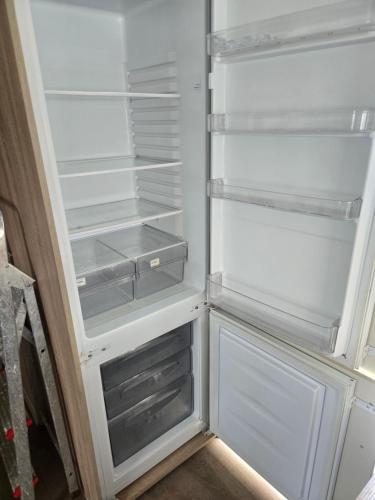 an empty refrigerator with its door open in a kitchen at F86 Steeple Bay in Steeple