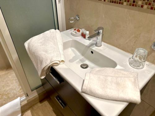 a bathroom with a white sink and a mirror at Bab louka in Aït Bou Zguia