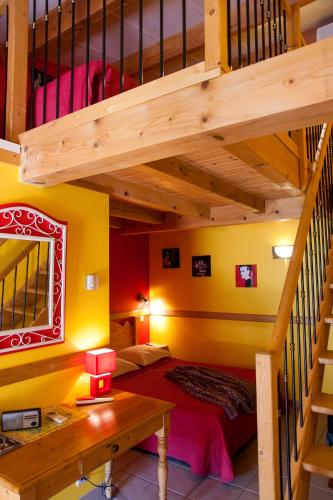 a bedroom with a bunk bed and a staircase at Hôtel La Garenne in Labeaume