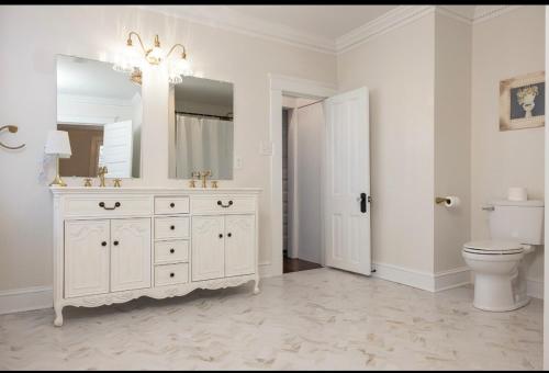 a white bathroom with a sink and a toilet at 5BR Historic Downtown Edenton in Edenton