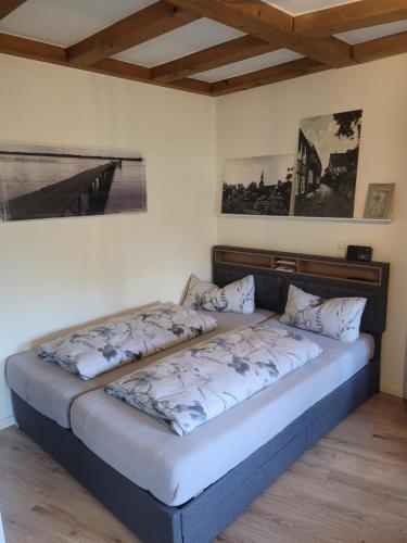 a bed in a room with two pillows on it at Gästewohnung Wasserzucht in Wunstorf