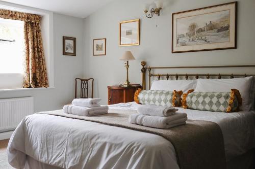 a bedroom with a bed with towels on it at Clock View - Haworth in Haworth