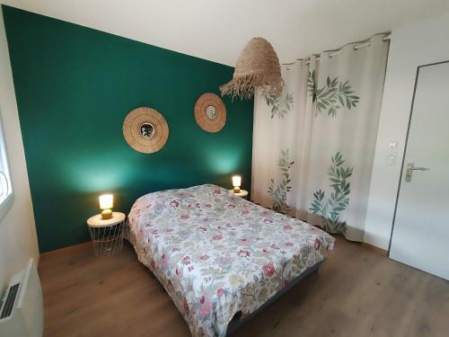 a bedroom with a bed with two candles on it at Maison Saint-Pardoux in Friaudour