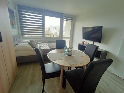 a small room with a table and a bed and a bedroom at Apartament Gliwice Centaura, dwa pokoje, klimatyzacja in Gliwice