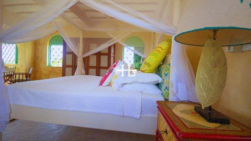 a bedroom with a bed with a canopy at Kavunjeni Villa in Uyombo