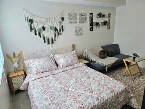 a bedroom with a bed and a couch at BE Residences Lahug in Cebu City