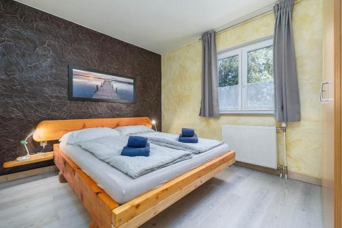 a bedroom with a bed with blue pillows on it at Maleluni in Malinska