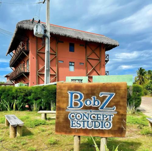 a sign in front of a resort with a building at BobZ Concept in Barrinha