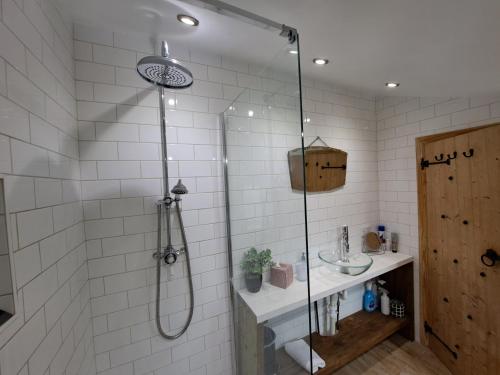 a bathroom with a shower and a sink at Rose Cottage Solway Self Catering in Cardurnock