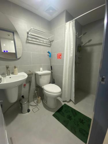 a bathroom with a toilet and a sink and a shower at Jbs place at Jtower Residences in Mandaue City