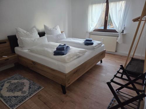 a bedroom with two beds with towels on them at Ferienwohnung Waldenburg Sachsen II in Waldenburg