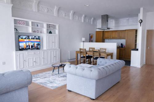 a living room with two couches and a tv at The Athenaeum in Sunderland
