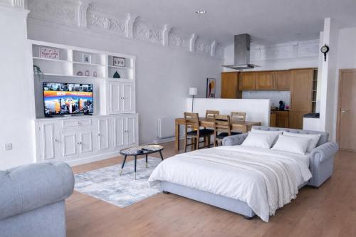 a bedroom with a bed and a dining room at The Athenaeum in Sunderland