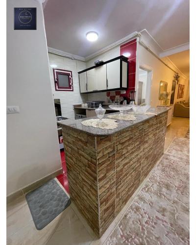 a large kitchen with a large counter in a room at Half Moon Apartaments in Alexandria