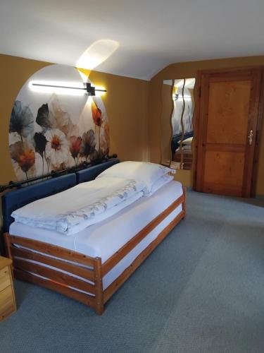 a bedroom with a large bed with avertisementatron at Kleines Haus am Wald in Rohrbach