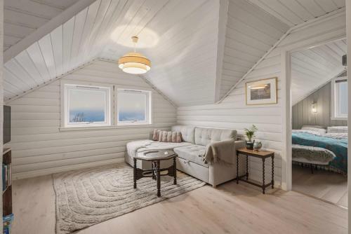 a living room with a couch and a bed at The Nordic Loft in Bergen