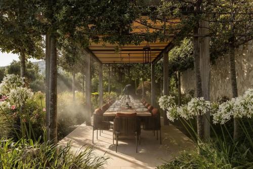 a table set for a meal under a pergola at Rose Bank in Johannesburg