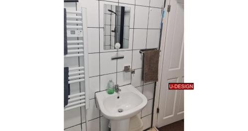 a bathroom with a toilet and a sink at Parkside Studio in Luton
