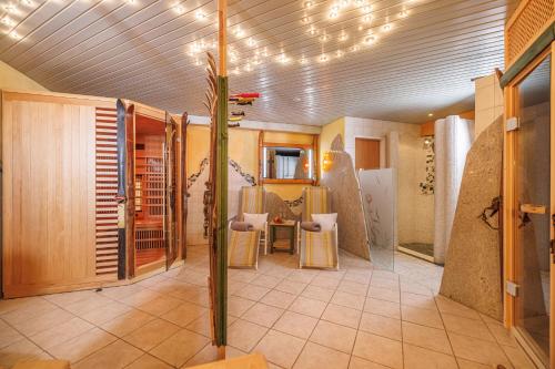 a room with a bathroom with a table and chairs at Appartements Innerthal in Inneralpbach
