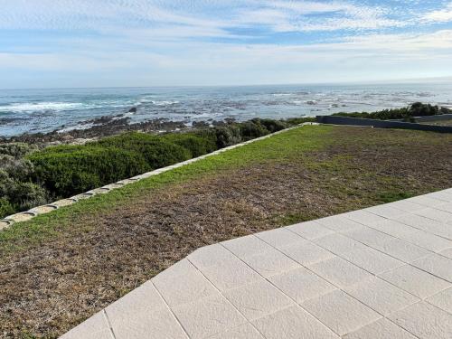 a walkway with a view of the ocean at The Lookout in Pearly Beach