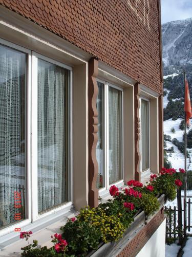 a balcony of a building with flowers on it at Casa Schuoler in Disentis