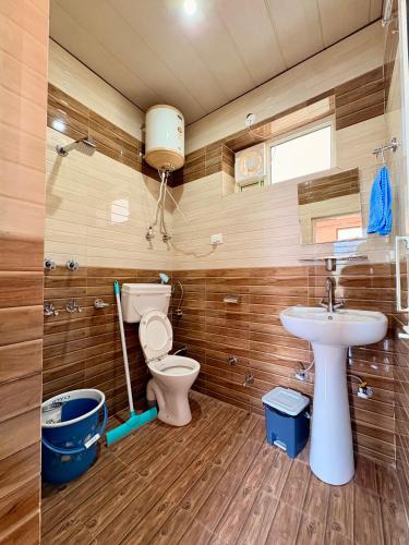 a bathroom with a toilet and a sink at Brekora X RajStays in McLeod Ganj