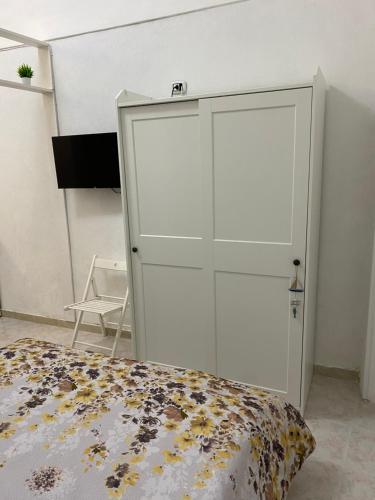 a bedroom with a white cabinet and a bed at Little house in Vasto